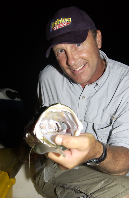 Mark "Chainsaw' Lawson points the business end of a barra at the business end of the camera.